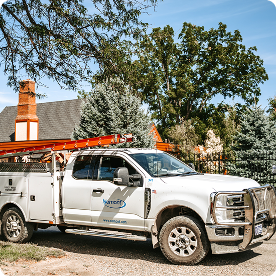 Nemont service technician truck parked in front of a house in Columbus, MT installing Fiber Internet